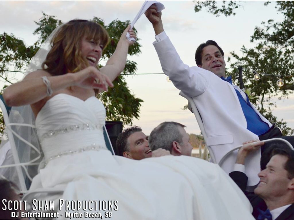 Up above the heads of the guests in the chairs with the Hora