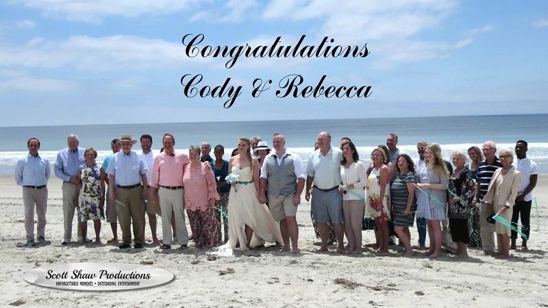 Cody and Rebecca with their friends and family after their beachside wedding with DJ Scott Shaw